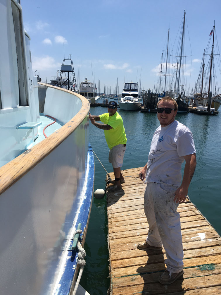 Painters painting boat