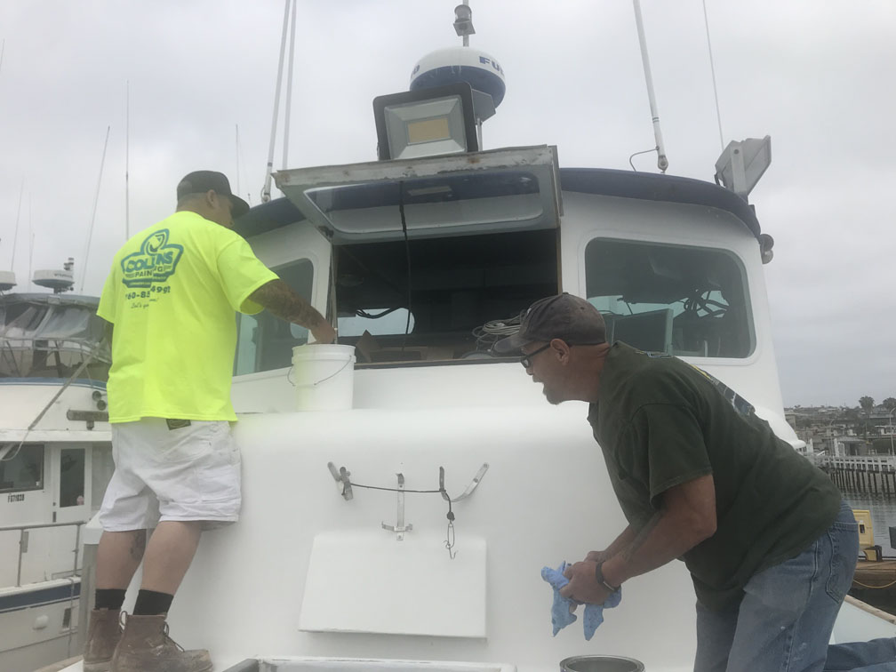 Painters painting boat