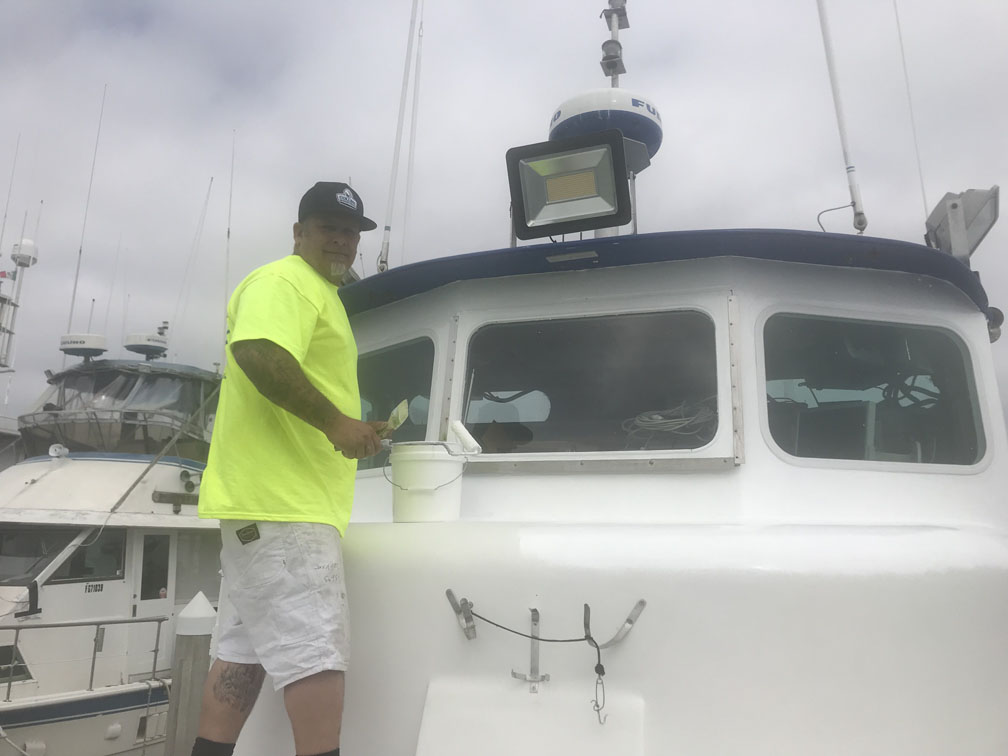 Painters painting boat