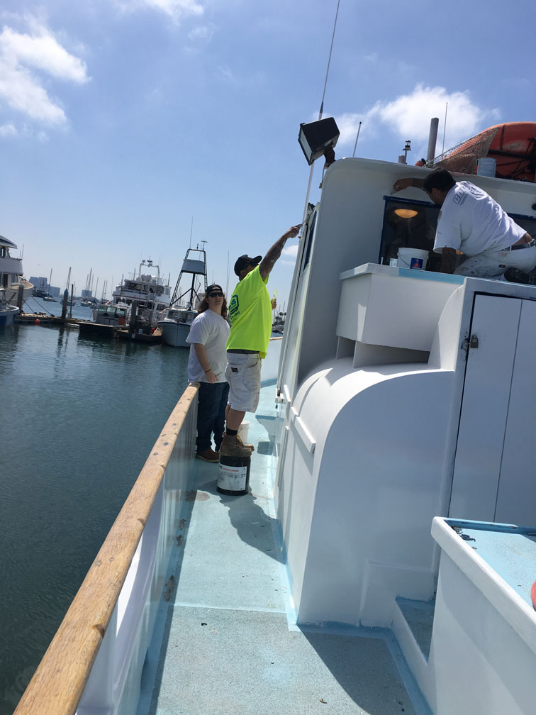 Painters painting boat
