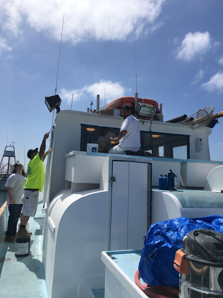 Painters painting boat