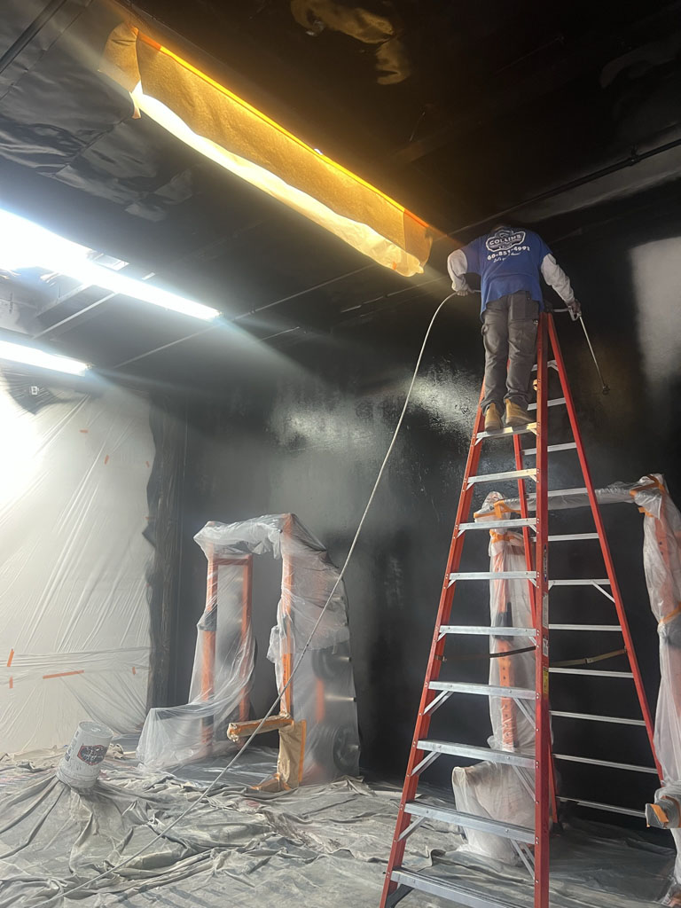 Painter by red wall during remodel